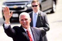 Vice President Mike Pence waves to the media after landing at the Roanoke-Blacksburg Regional A ...