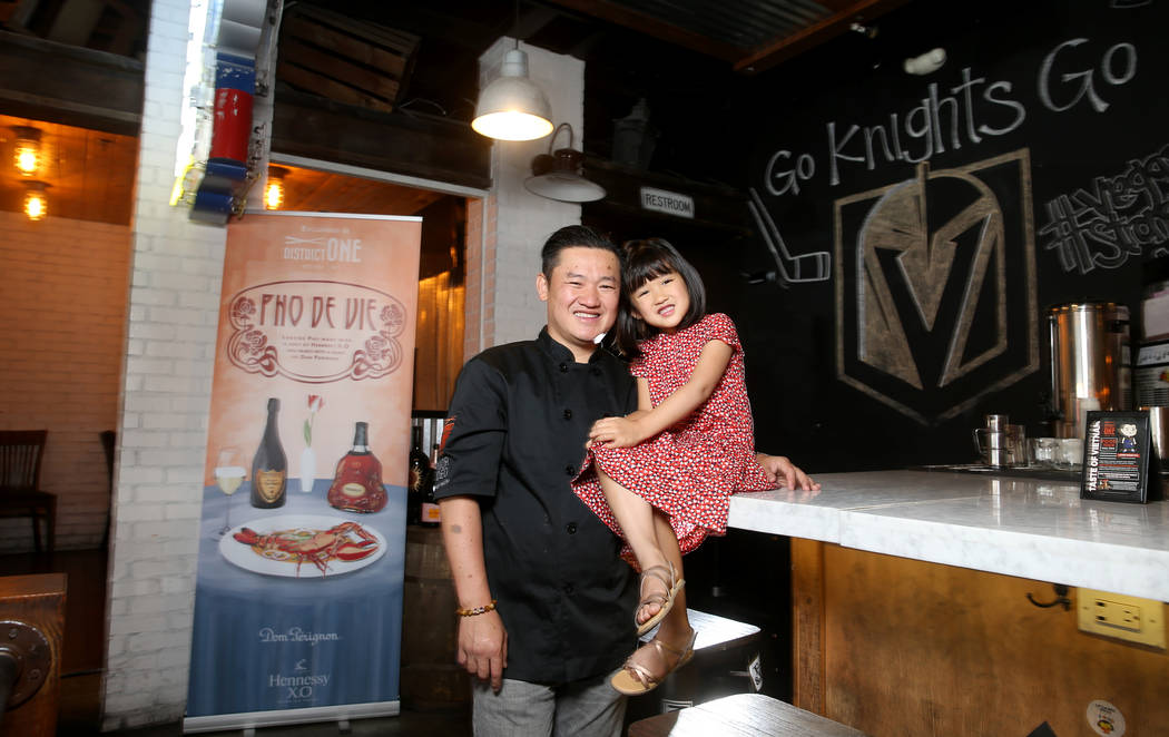 Chef Khai Vu and his daughter, Audrey, 5, at District One Kitchen & Bar in Las Vegas Monday ...