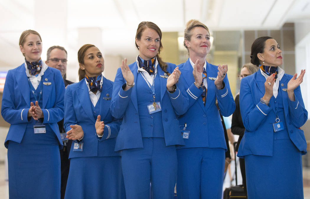 Crew members with KLM Royal Dutch Airlines clap during a ribbon cutting ceremony at McCarran In ...