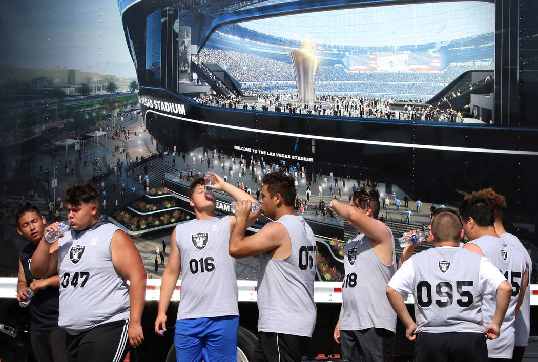 Clark County-area high school football players take a break as they participate in fundamental ...