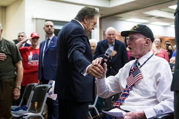World War II veteran William Dunsmore leads the Pledge of Allegiance during a ceremony commemor ...