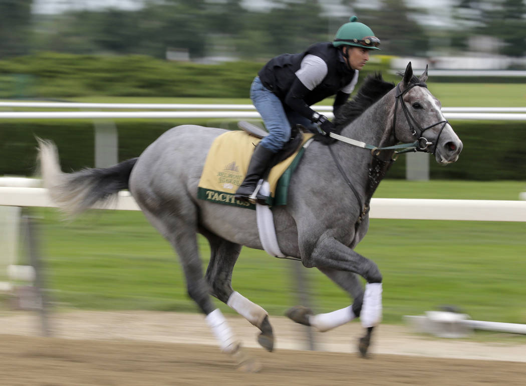 Exercise rider Joe Ramos rides Tacitus during workouts at Belmont Park in Elmont, N.Y., Wednesd ...