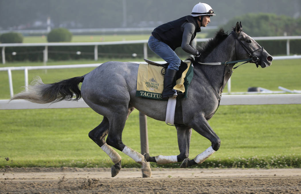 Exercise rider Joe Ramos rides Tacitus during a workout at Belmont Park in Elmont, N.Y., Thursd ...