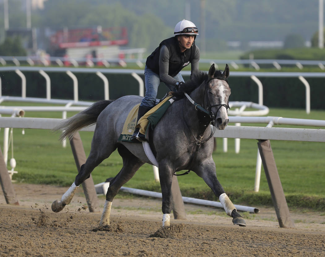 Exercise rider Joe Ramos rides Tacitus during a workout at Belmont Park in Elmont, N.Y., Thursd ...