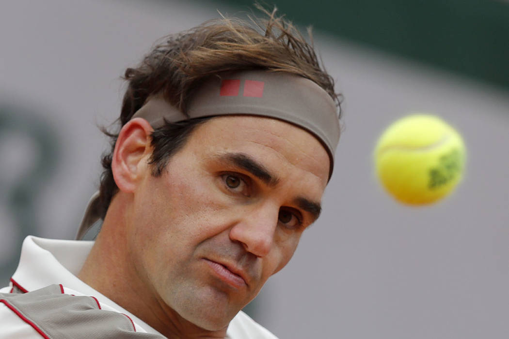 Switzerland's Roger Federer eyes the ball as he plays a shot against Spain's Rafael Nadal durin ...