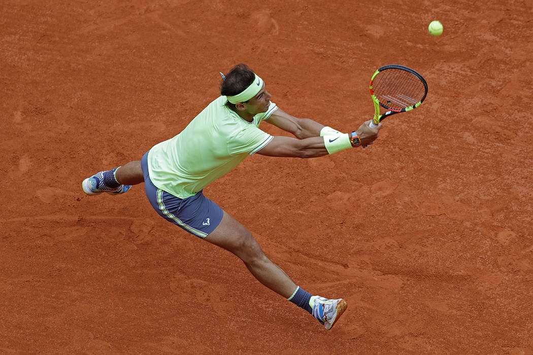 Spain's Rafael Nadal plays a shot against Switzerland's Roger Federer during their semifinal ma ...