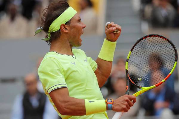 Spain's Rafael Nadal clenches his fist after scoring a point against Switzerland's Roger Federe ...
