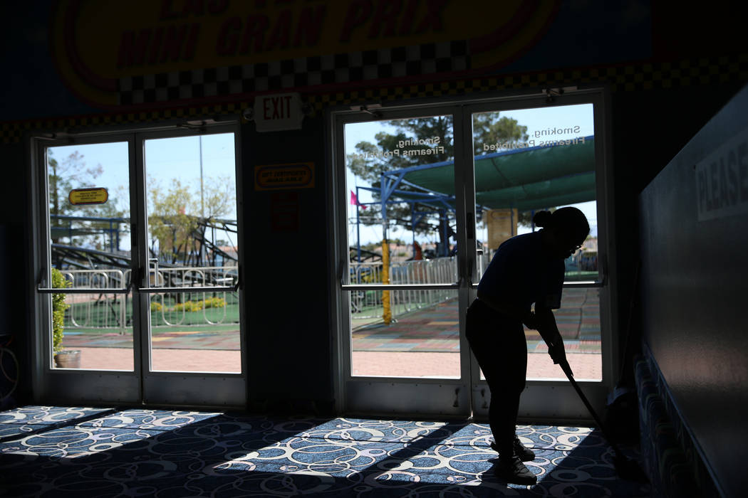 Canyon Springs High School graduate Angelica Tariman, 17, sweeps the floor at the Las Vegas Min ...