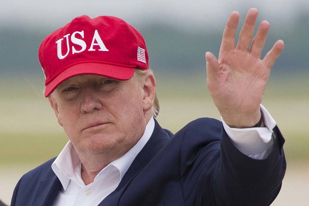 President Donald Trump waves as he steps off Air Force One after arriving, Friday, June 7, 2019 ...