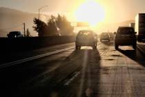 In this Aug. 31, 2018, photo morning commuters drive into downtown Los Angeles as the sun rises ...