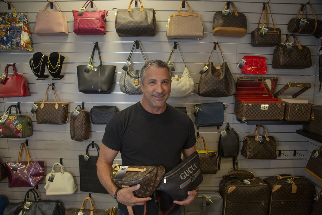 Michael Mack stands in front of luxury purses at Max Pawn in Las Vegas, Thursday, June 6, 2019. ...