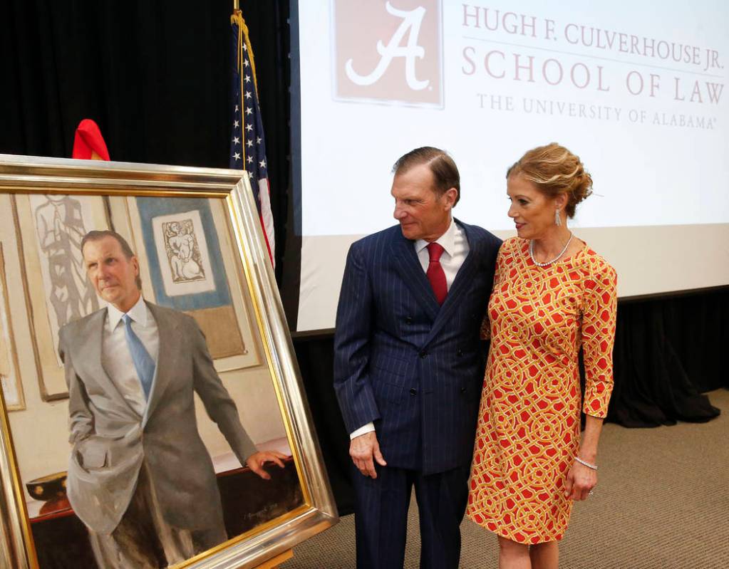 In this Sept. 20, 2018, photo, Hugh F. Culverhouse Jr. and his wife, Eliza, look at a portrait ...