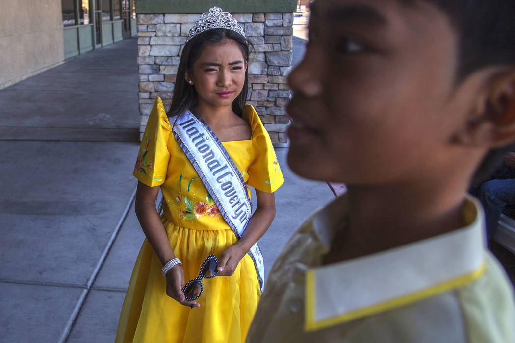 Siblings Sophia Natividad, 9, left, and Maverick Santos, 11, right, wait before the fourth annu ...