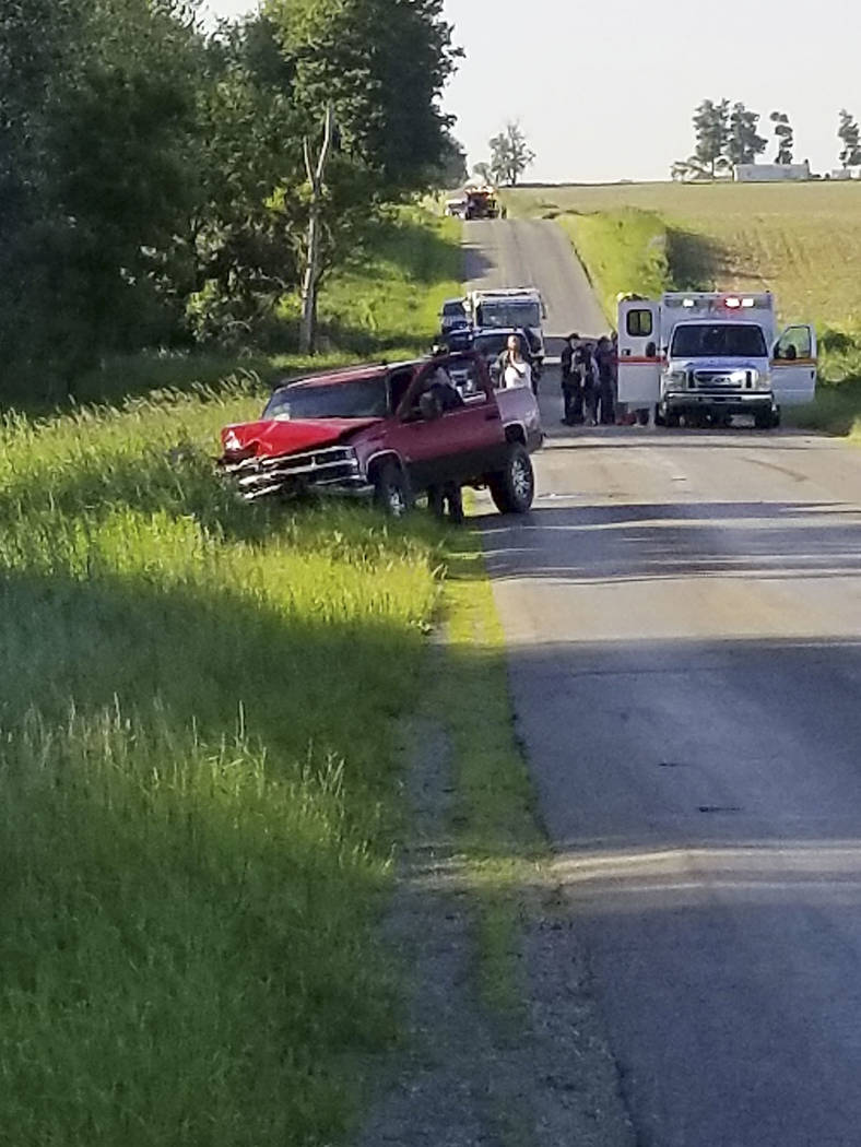 A damaged truck sits on the side of the road after an accident involving a horse-drawn carriag ...