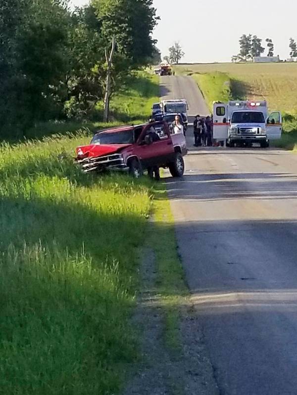 A damaged truck sits on the side of the road after an accident involving a horse-drawn carriag ...