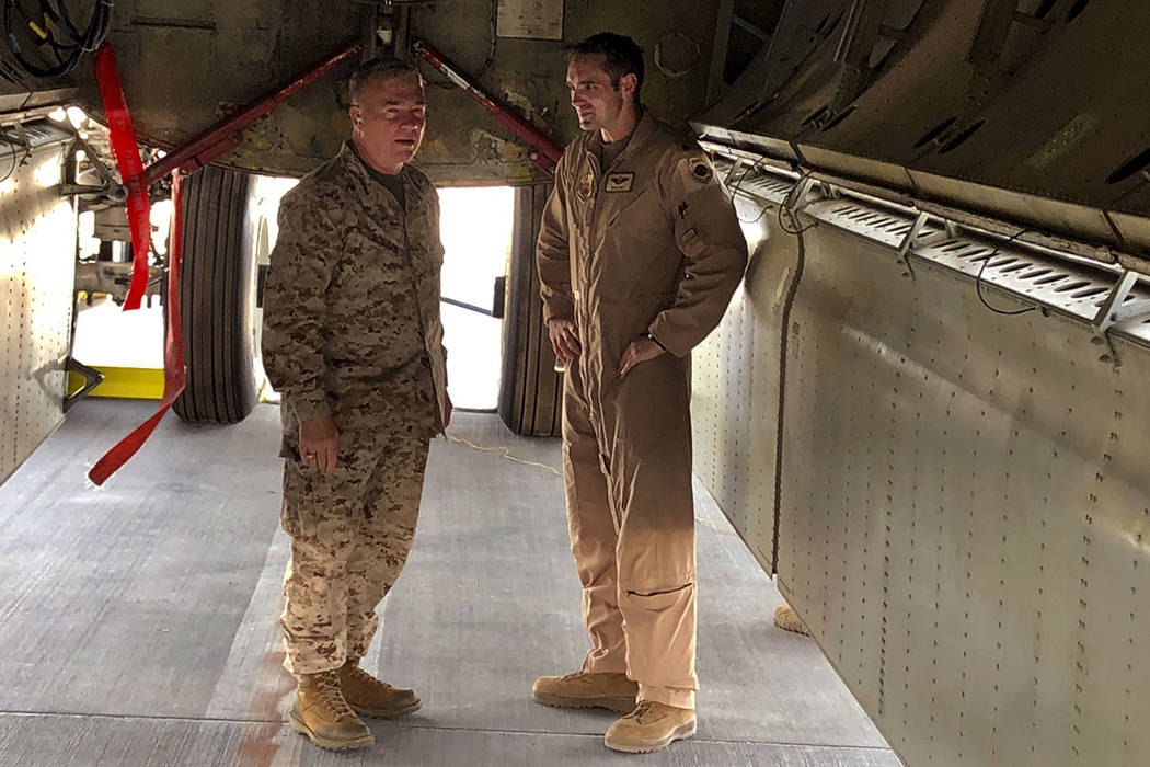 Marine Gen. Frank McKenzie, head of U.S. Central Command, confers with an Air Force officer bel ...