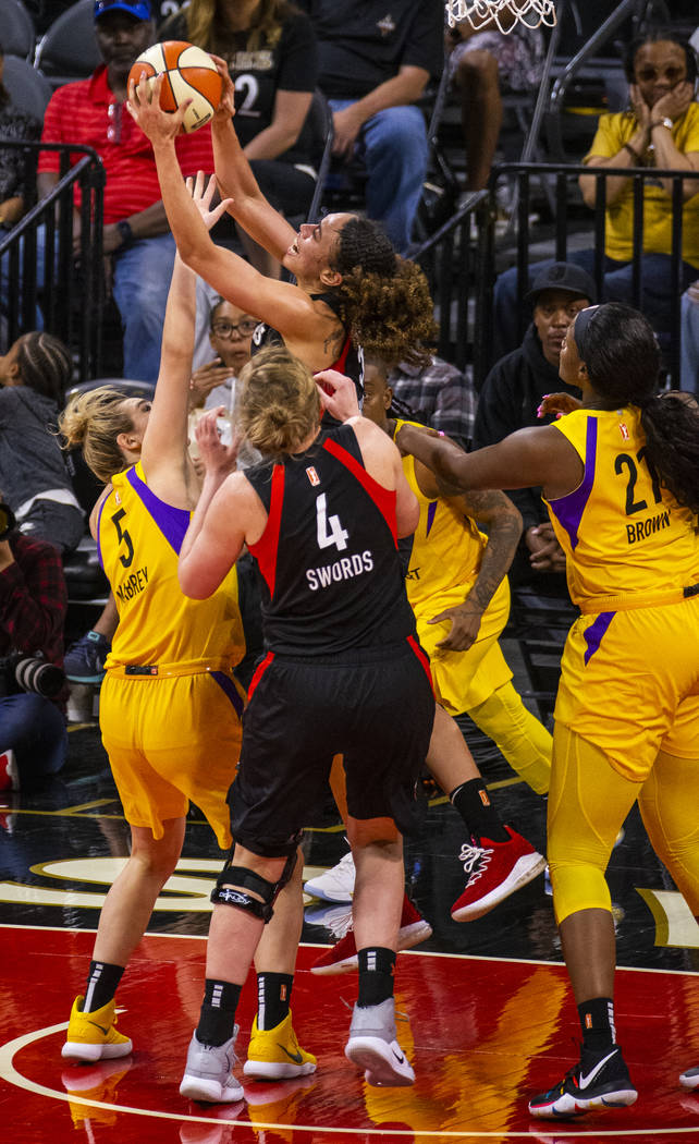 Las Vegas Aces forward Dearica Hamby (5) pulls down a rebound over Los Angeles Sparks guard Mar ...