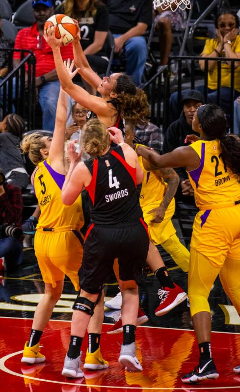 Las Vegas Aces forward Dearica Hamby (5) pulls down a rebound over Los Angeles Sparks guard Mar ...