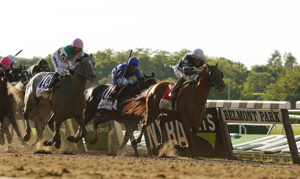 Sir Winston (7), with jockey Joel Rosario up, crosses the finish line to win the 151st running ...