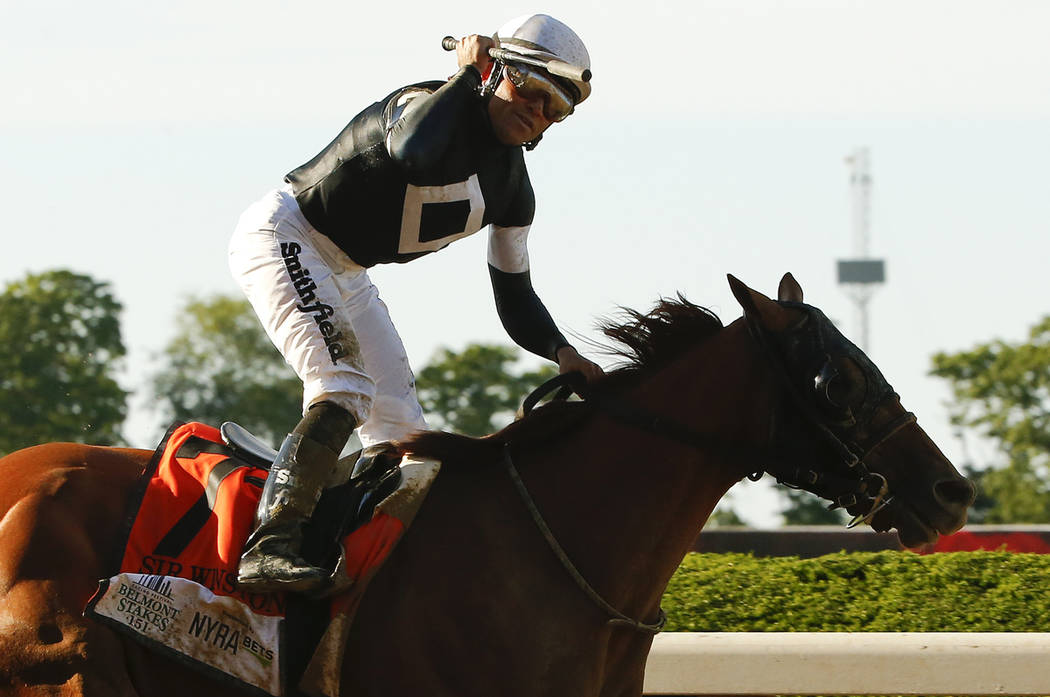 Jockey Joel Rosario celebrates atop Sir Winston (7) after winning the 151st running of the Belm ...