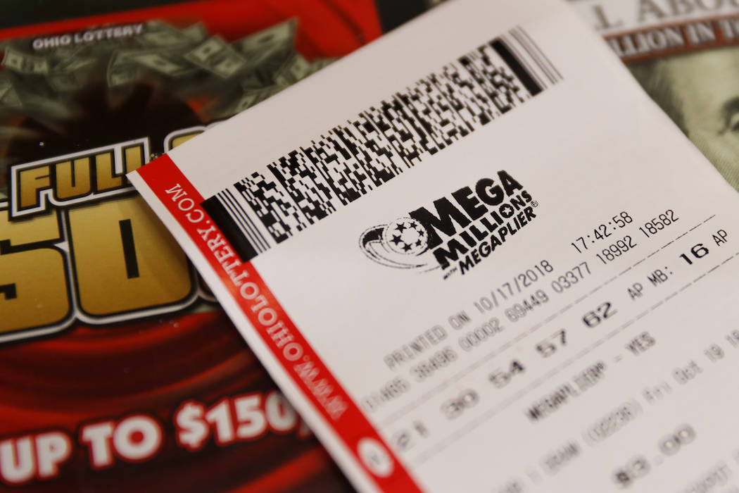 A Mega Millions lottery ticket rests on a shop counter. (AP Photo/John Minchillo)