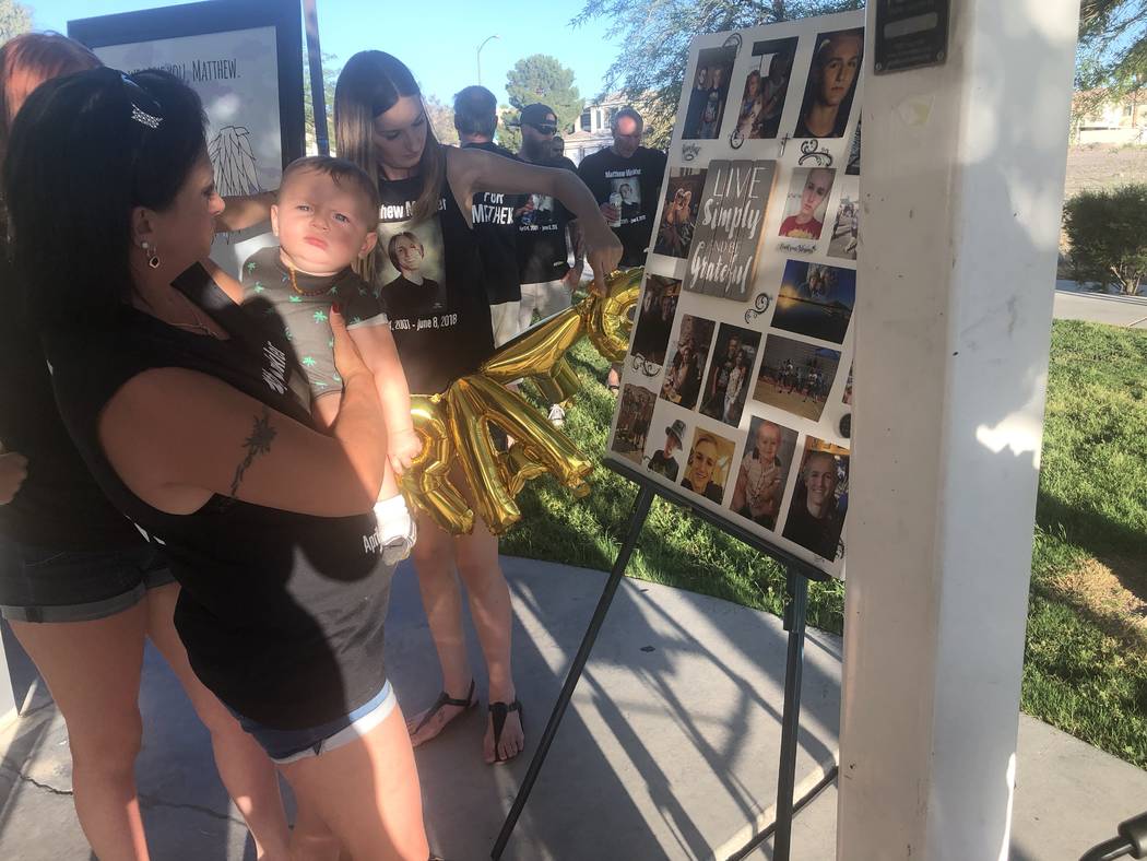 Samantha Valentine, 27, holds balloons while a family friend shows her son, 7-month-old Matthew ...