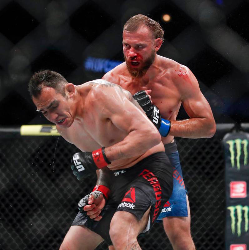 Donald Cerrone, right, looks to hit Tony Ferguson during their lightweight mixed martial arts b ...