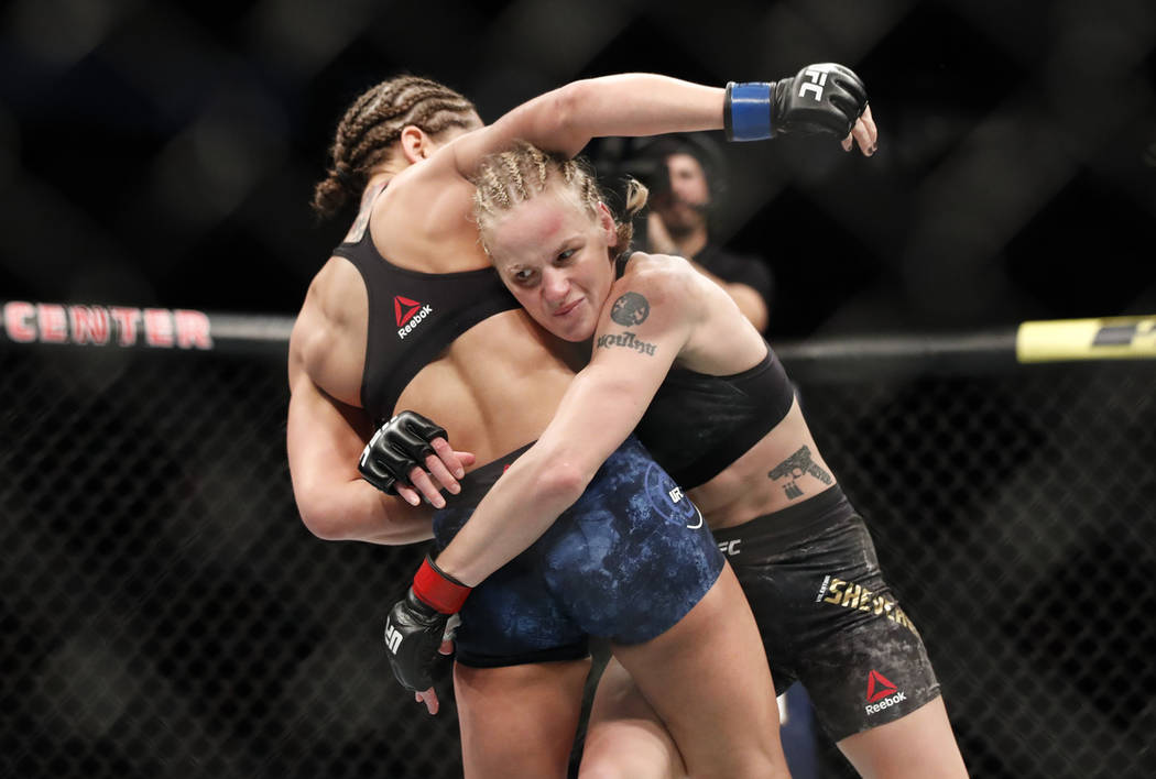 Valentina Shevchenko, right, tries to take down Jessica Eye during their women's flyweight titl ...