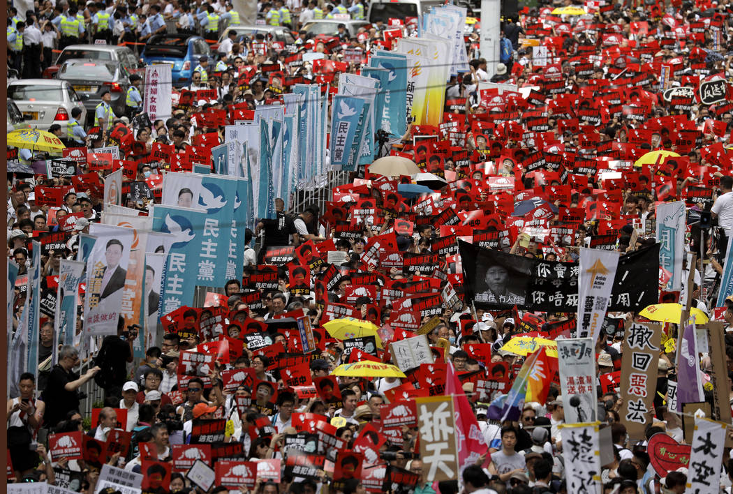 Protesters march along a downtown street against the proposed amendments to an extradition law ...