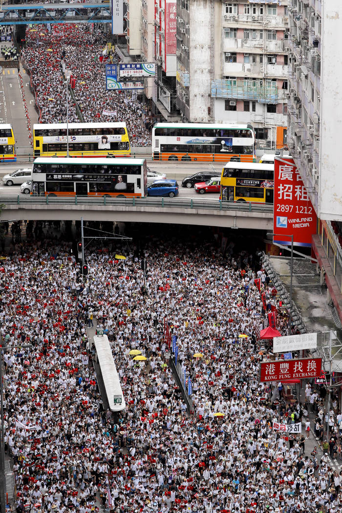 Protesters march in a rally against the proposed amendments to an extradition law in Hong Kong, ...