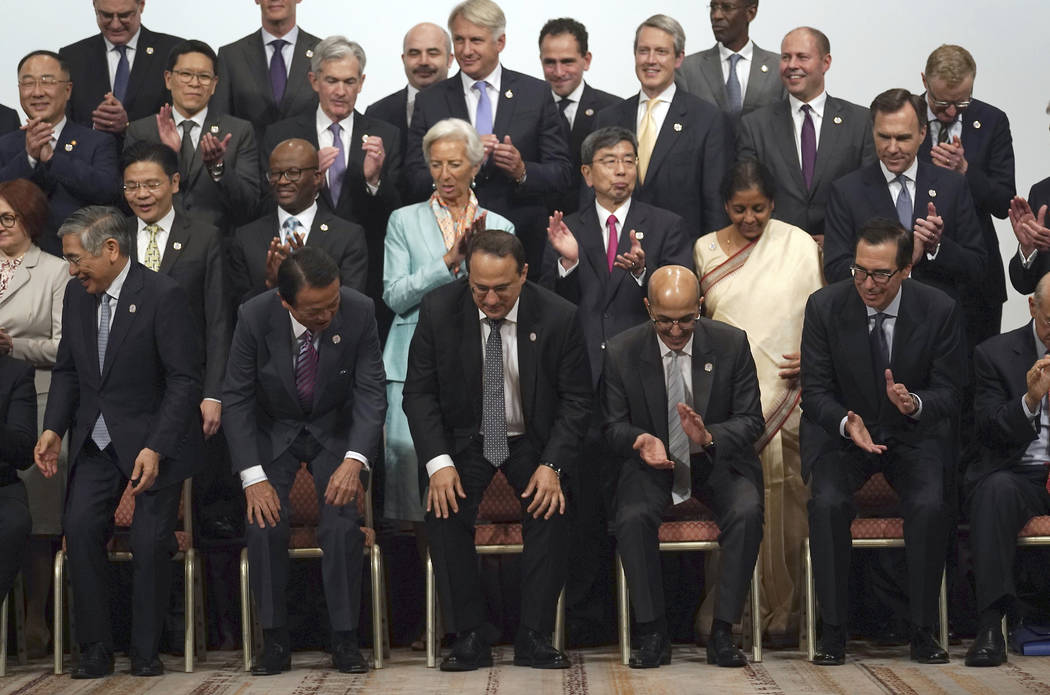 Participants finish their family photo session of the G20 finance ministers and central bank go ...