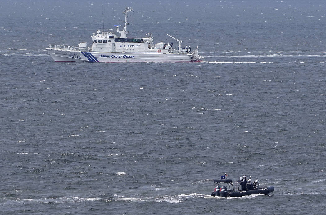 Japanese coast guard ship and security personnel patrol at sea near the venue of G20 Finance Mi ...