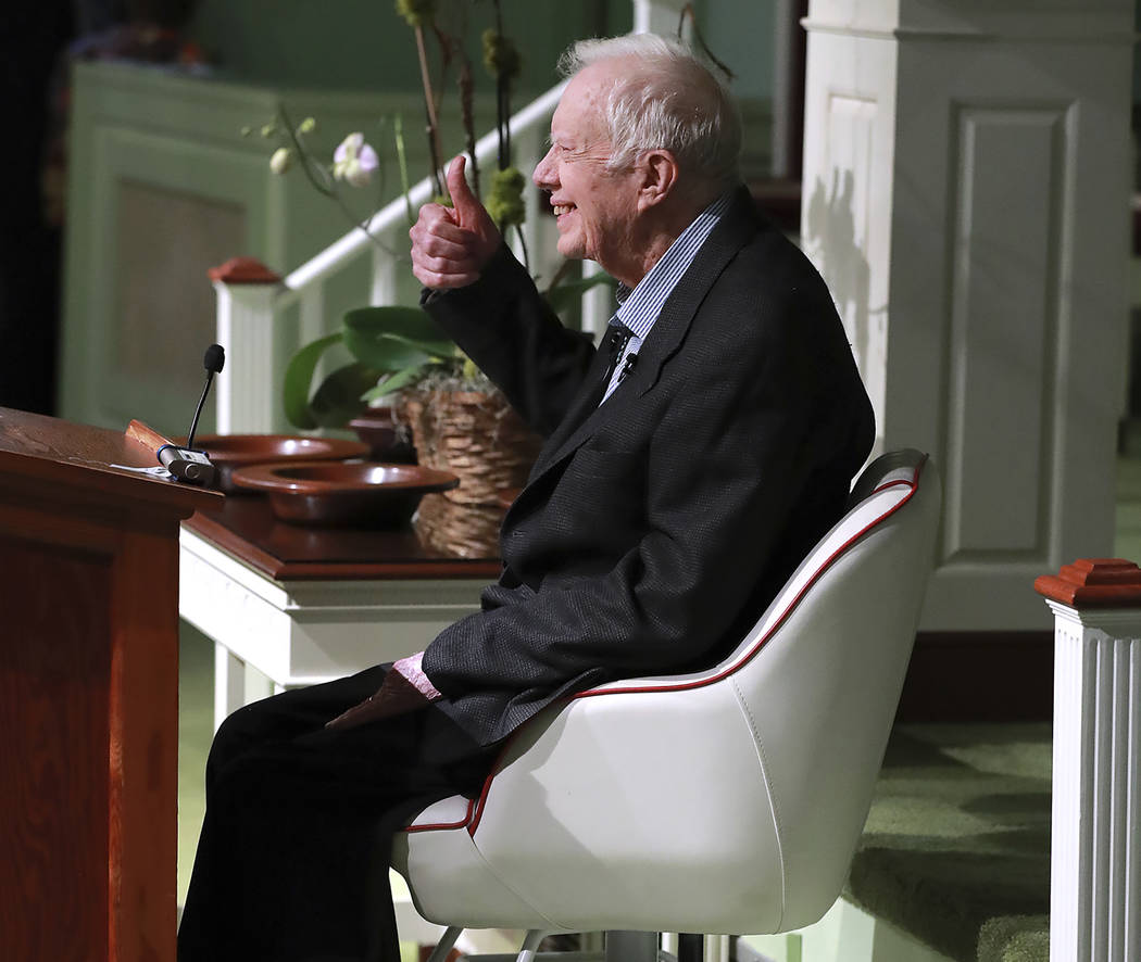 Former President Jimmy Carter smiles and gives the thumbs up as he returns to Maranatha Baptist ...