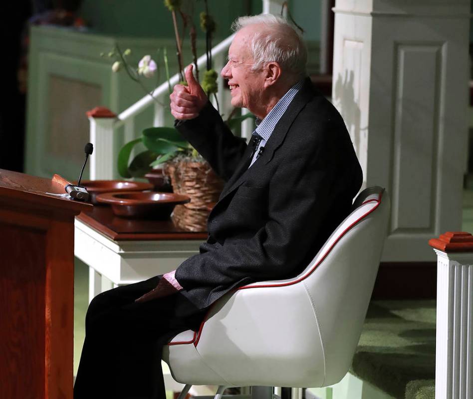 Former President Jimmy Carter smiles and gives the thumbs up as he returns to Maranatha Baptist ...