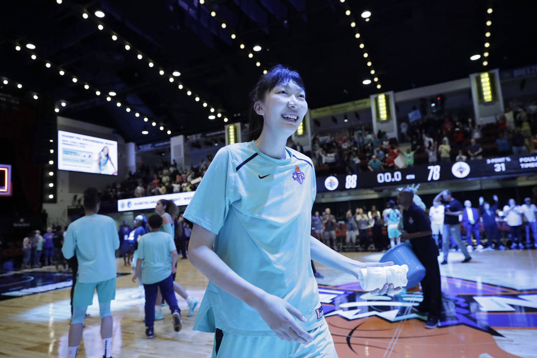 New York Liberty's Han Xu, of China, gets ready to throw a souvenir towel to fans after her tea ...