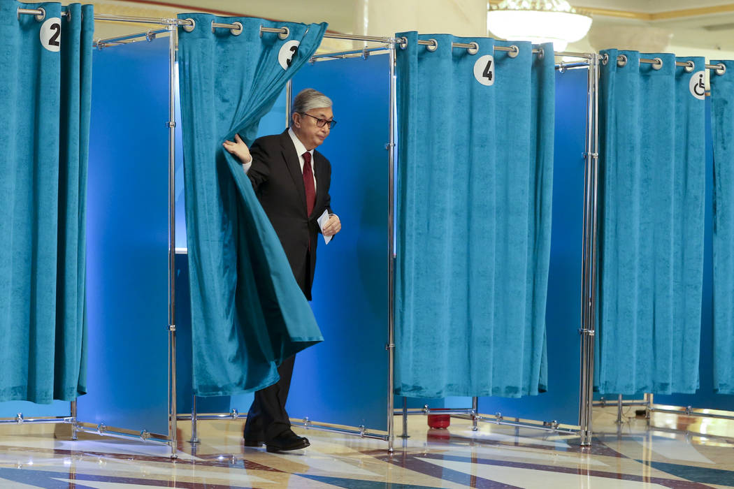 Kazakhstan's acting President Kassym-Jomart Tokayev leaves a booth at a polling station during ...