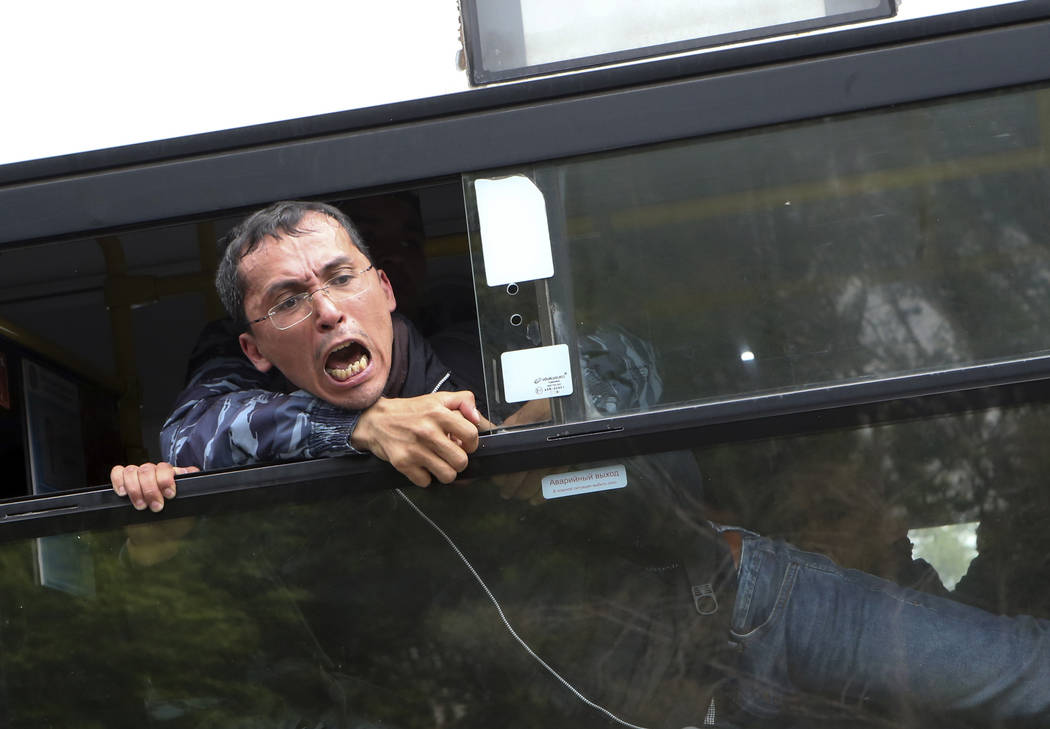 A detained demonstrator shouts from a police bus during an anti-government protest during the p ...