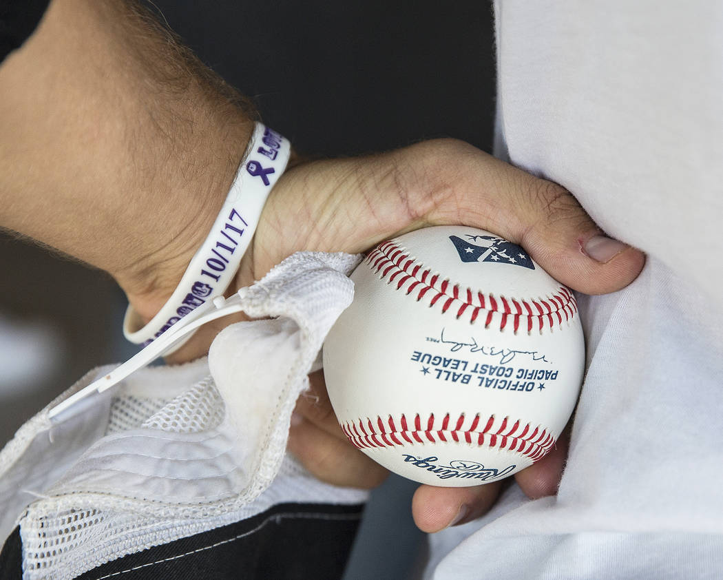 Kaden Manczuk holds a baseball after throwing out the first pitch before the start of the Las V ...