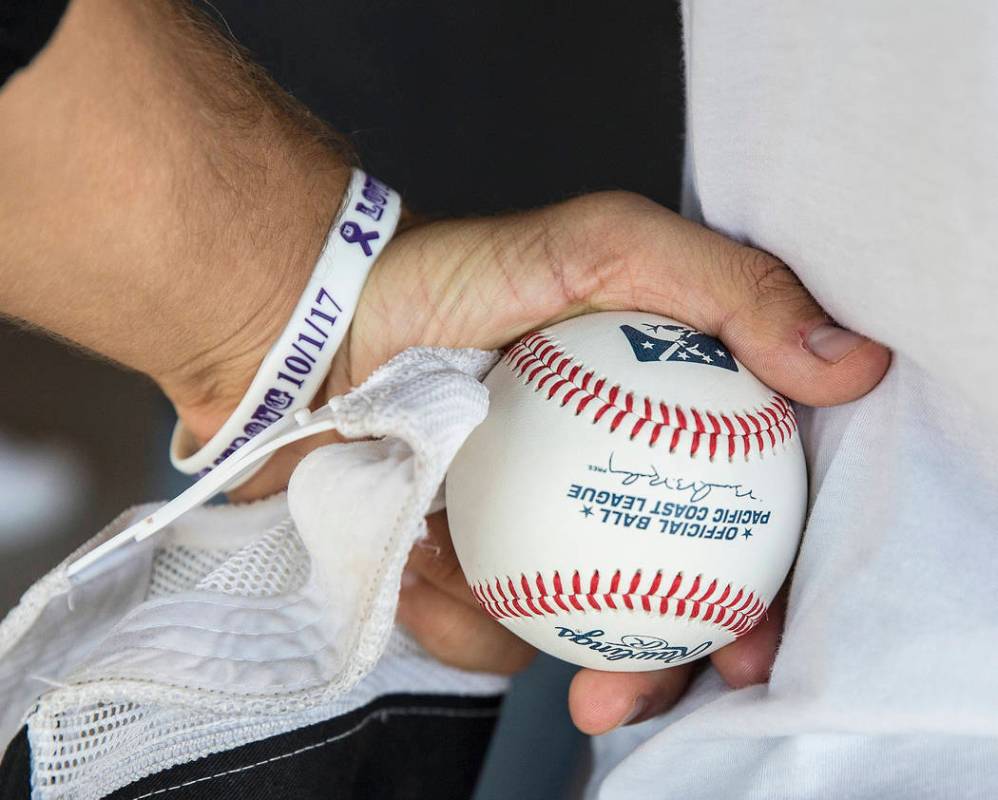 Kaden Manczuk holds a baseball after throwing out the first pitch before the start of the Las V ...