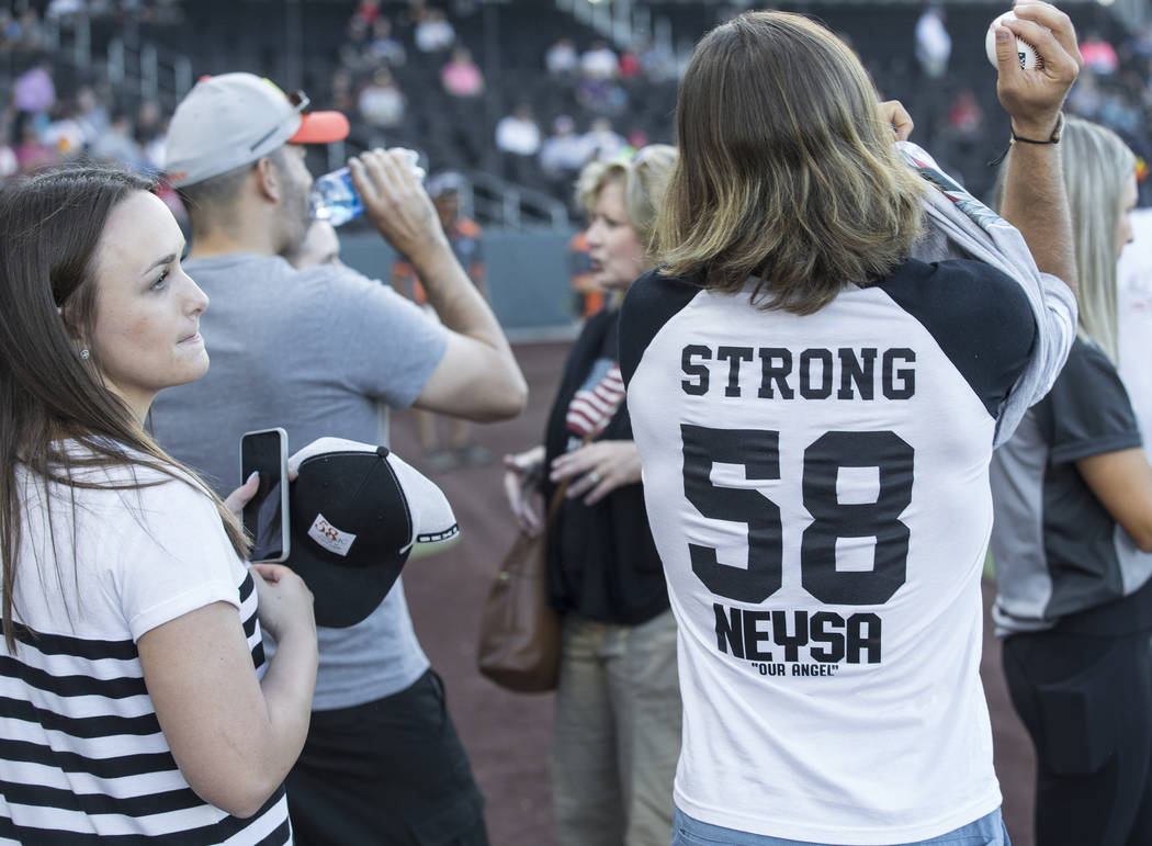 Kaden Manczuk, right, prepares to throw out the first pitch before the start of the Las Vegas A ...