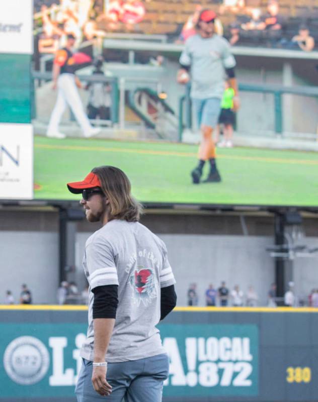 Kaden Manczuk walks onto the field to throw out the first pitch before the start of the Las Veg ...