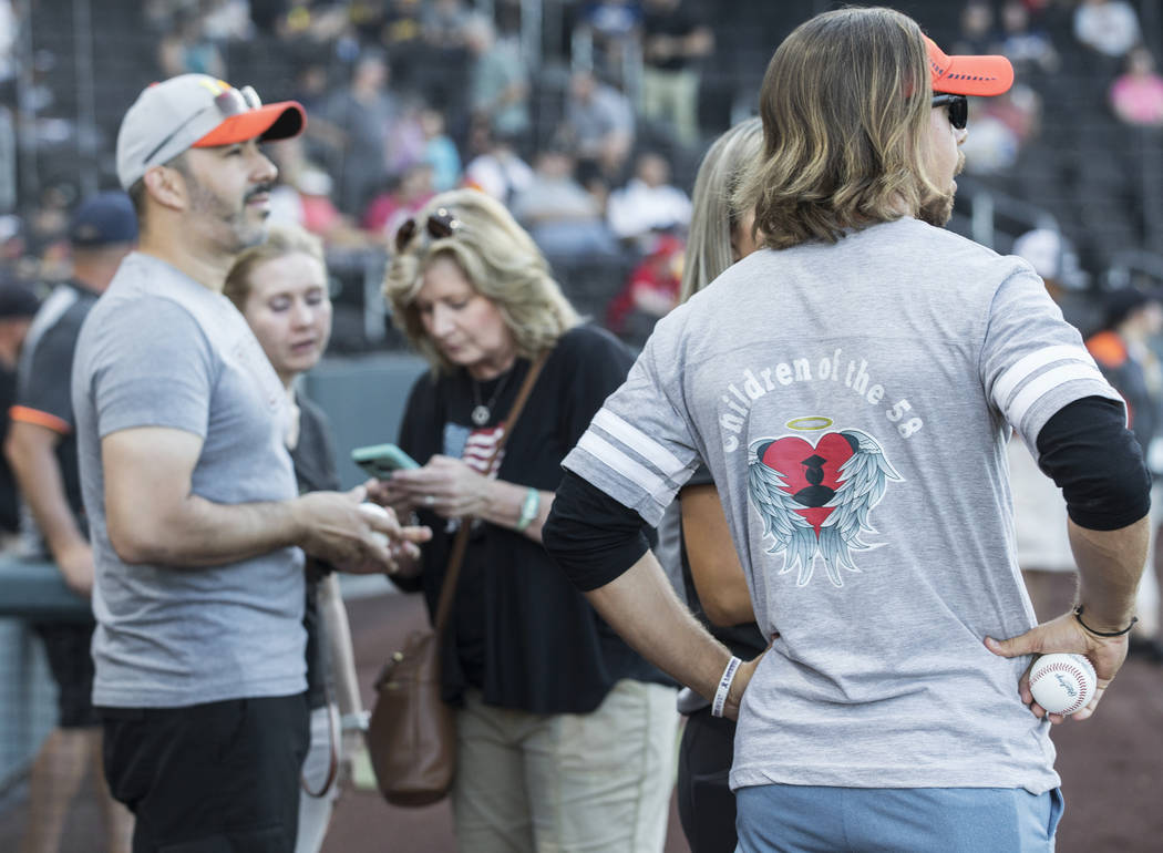 Kaden Manczuk, right, prepares to throw out the first pitch before the start of the Las Vegas A ...