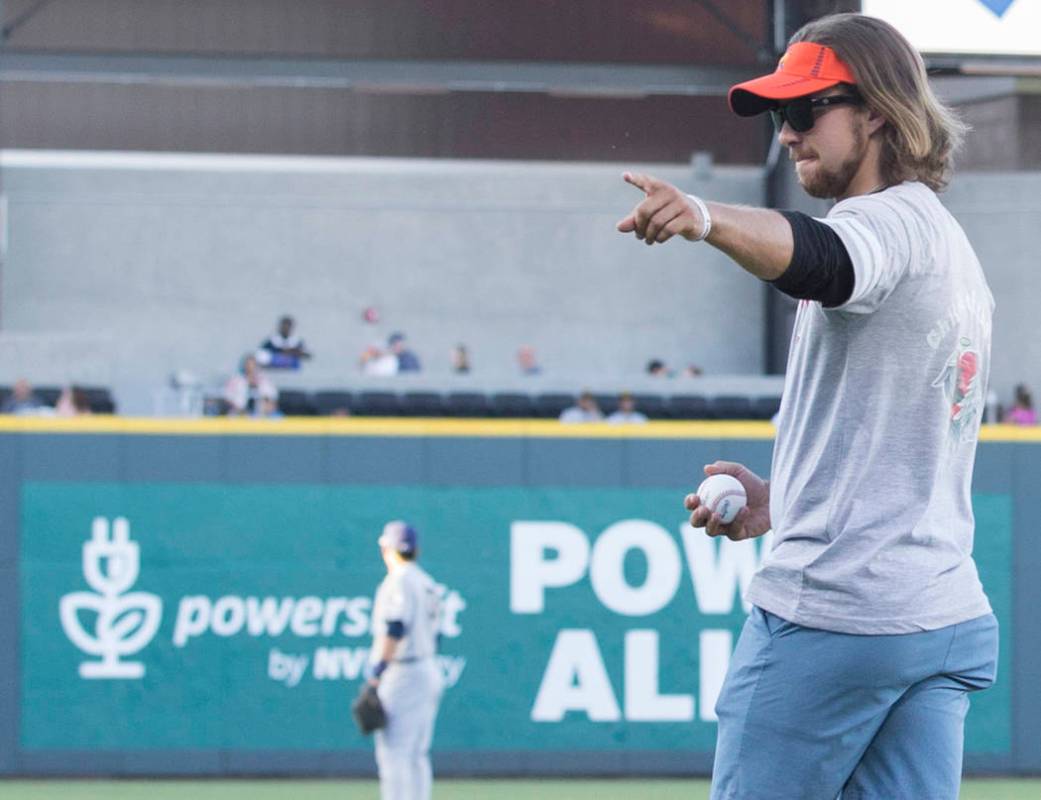 Kaden Manczuk walks onto the field to throw out the first pitch before the start of the Las Veg ...