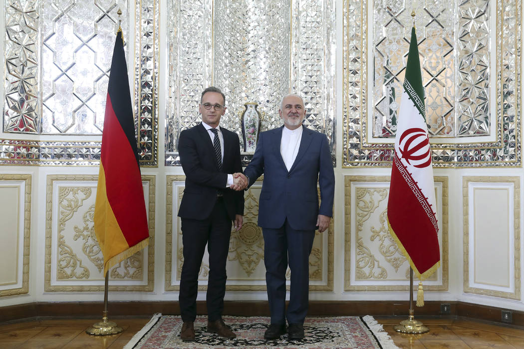 Iranian Foreign Minister Mohammad Javad Zarif, right, and his German counterpart Heiko Maas sha ...