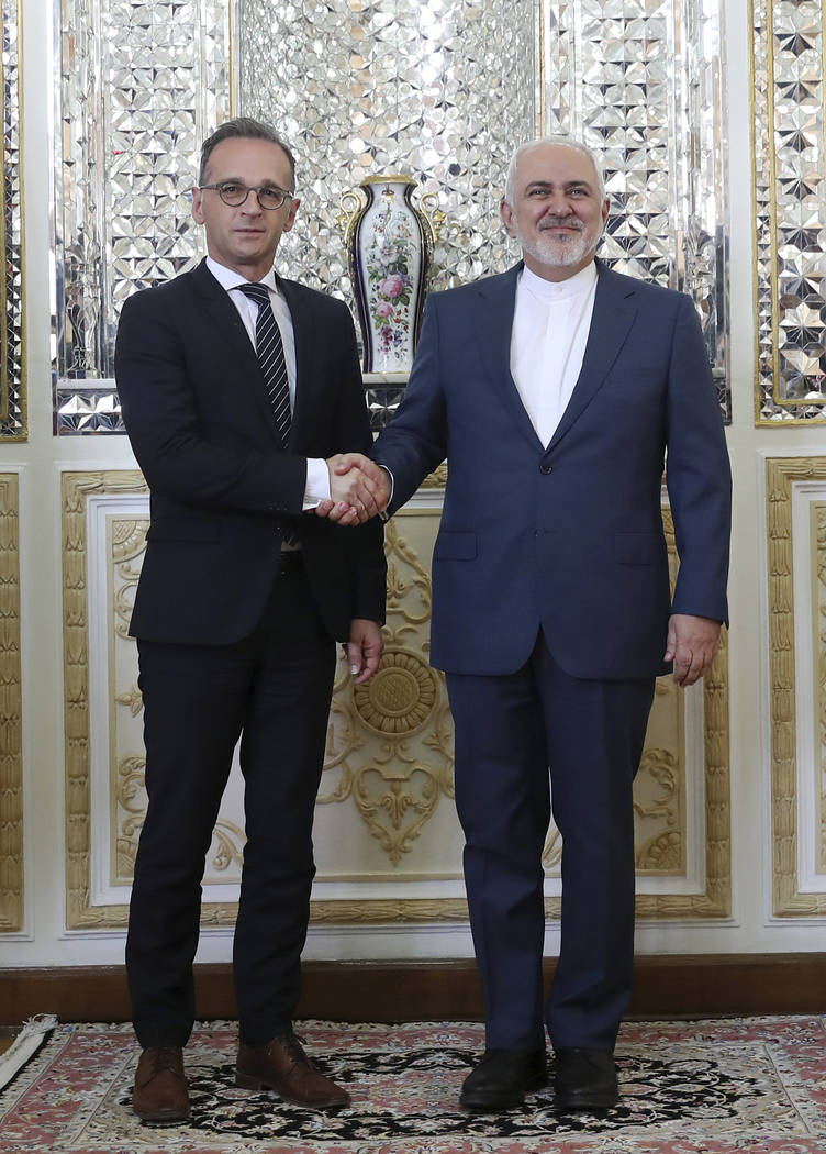 Iranian Foreign Minister Mohammad Javad Zarif, right, and his German counterpart Heiko Maas sha ...