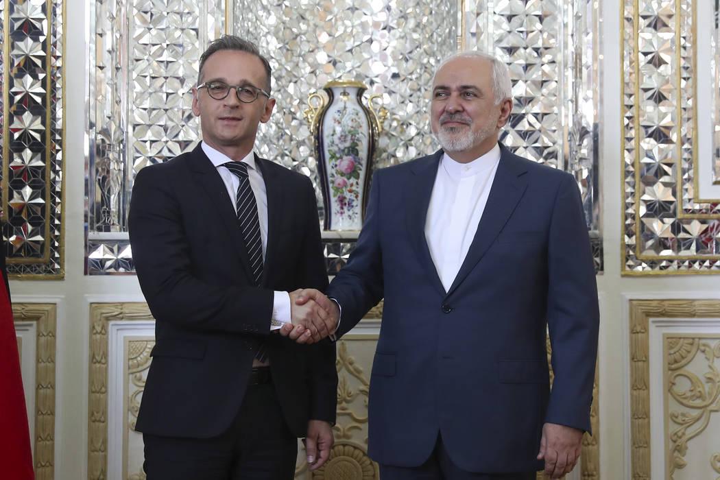 Iranian Foreign Minister Mohammad Javad Zarif, right, and his German counterpart Heiko Maas sha ...