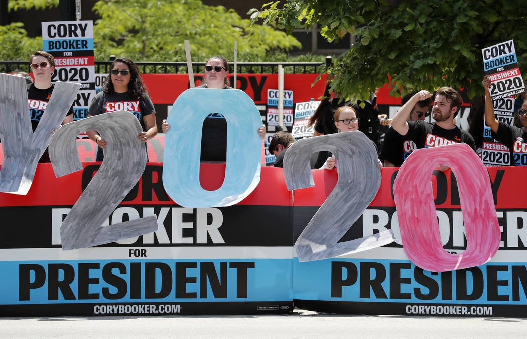 Supporters for Democratic presidential candidate Cory Booker hold signs outside the Iowa Democr ...