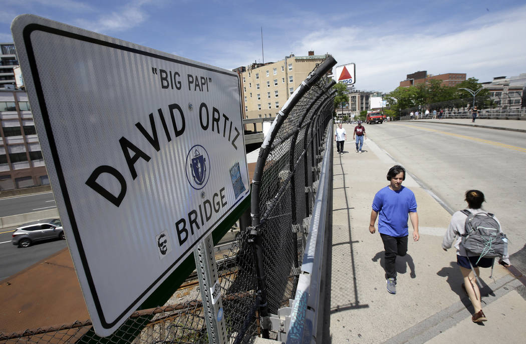 Passers-by walk over a bridge named for former Boston Red Sox slugger David Ortiz near Fenway P ...