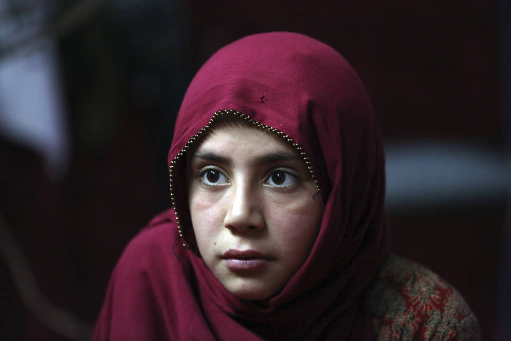 In this Thursday, May 30, 2019 photo, Shoghla, daughter of Farmanullah Shirzad whose family fl ...