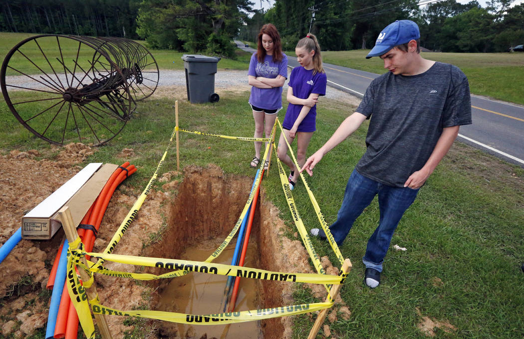 In this May 8, 2019, photograph, Riley Shaw, right, and his youngest sister, Leah, center, and ...